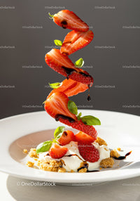 Floating sliced strawberries with cream and balsamic drizzle