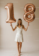 Young woman celebrating 18th birthday with balloons