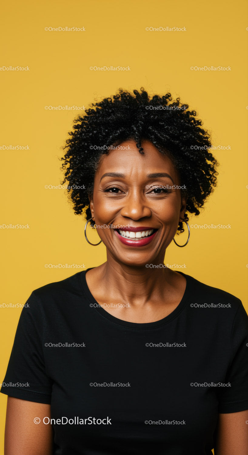 Confident Smiling Woman with Curly Hair Against Bright Yellow Background