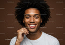 Happy Young Woman with Afro Hair Smiling in Studio Portrait