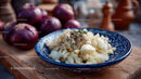 Chopped Onions in Traditional Blue Ceramic Bowl on Wooden Surface