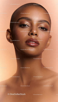 Close-up Portrait of Woman with Shaved Head and Glossy Makeup