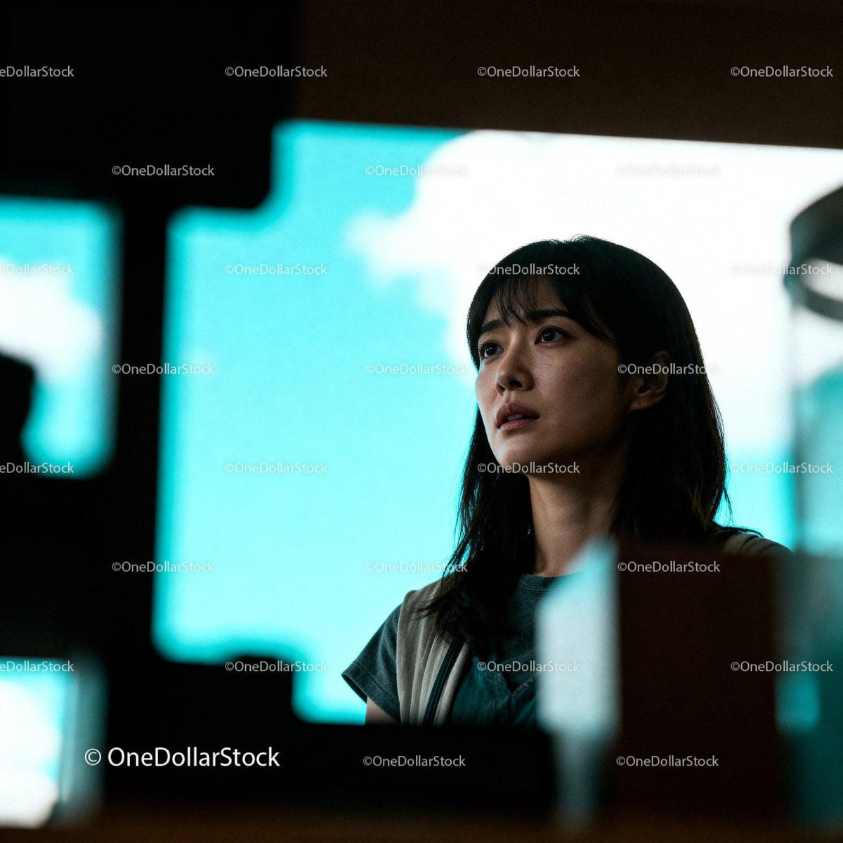 Young woman lost in thought against bright blue sky