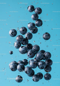 Fresh blueberries suspended in clear water with bubbles