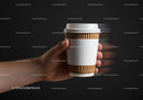 Hand Holding Disposable Coffee Cup with Blank Label