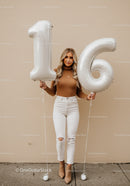 Smiling young woman celebrating her sixteenth birthday