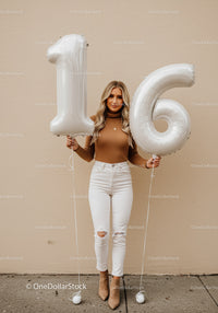 Smiling young woman celebrating her sixteenth birthday