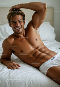 Smiling athletic man relaxing on bed in white briefs
