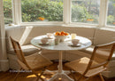 Cozy breakfast nook with natural light and fresh oranges