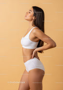 Young Woman in White Sportswear Posing for Fitness and Wellness