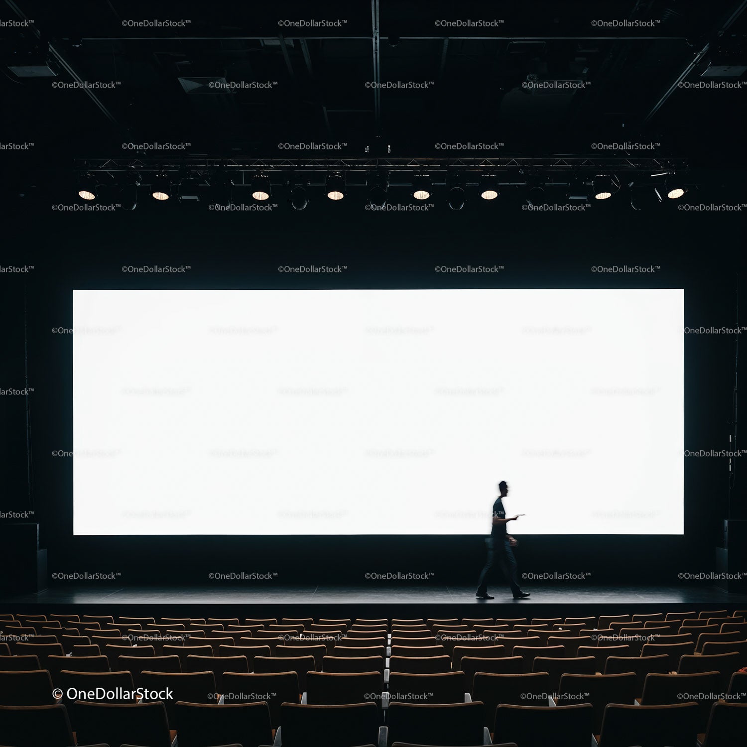 Silhouette of man walking in empty modern theater