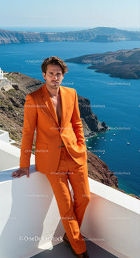 Man in vibrant orange suit overlooking deep blue sea