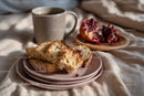 Sliced bread with coffee and pomegranate on cozy breakfast setting
