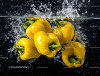 Vibrant Yellow Bell Peppers Under Water Splash in Bright Kitchen Scene