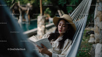 Relaxing Woman Reading in Hammock Surrounded by Nature