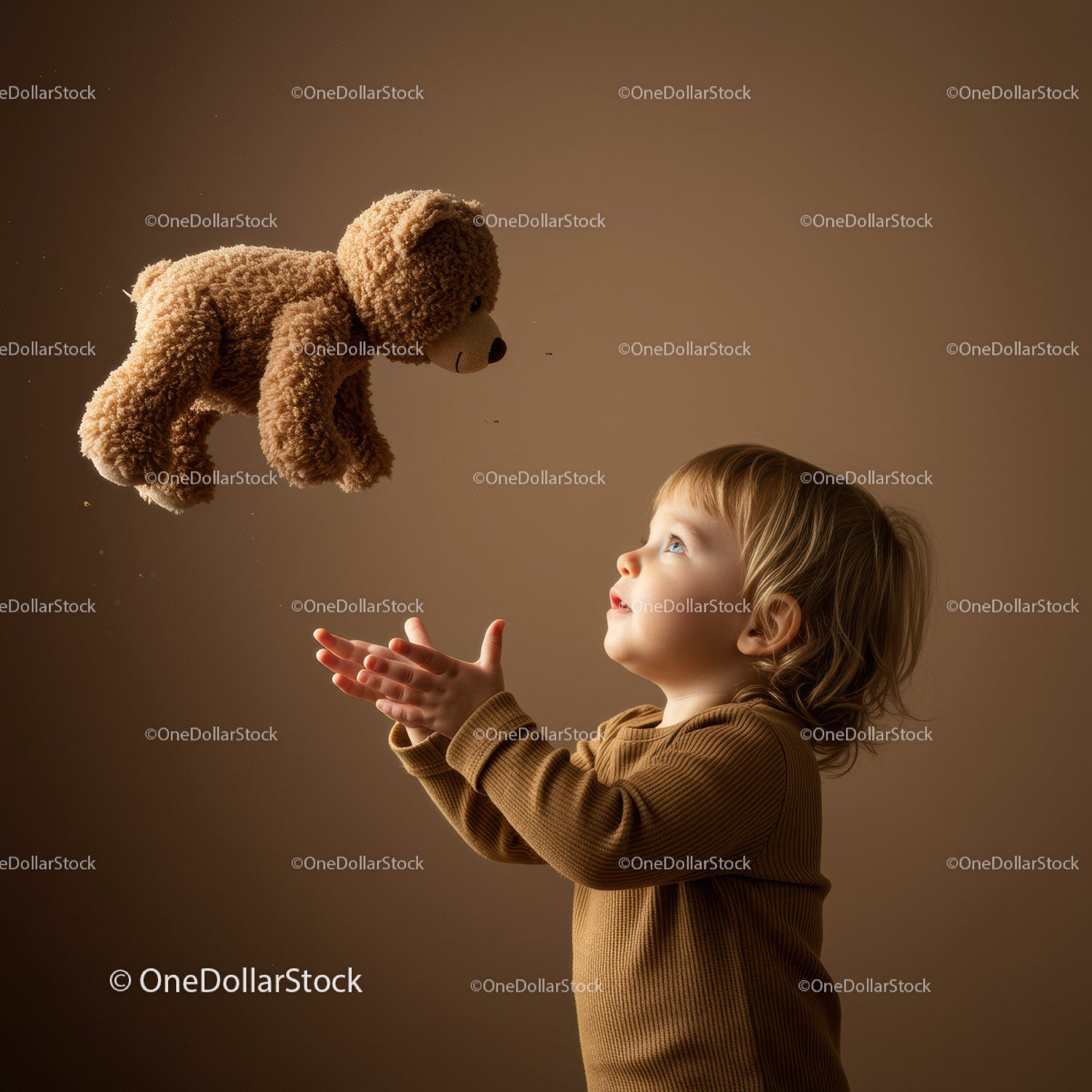 Toddler Catching Plush Teddy Bear with Wonder