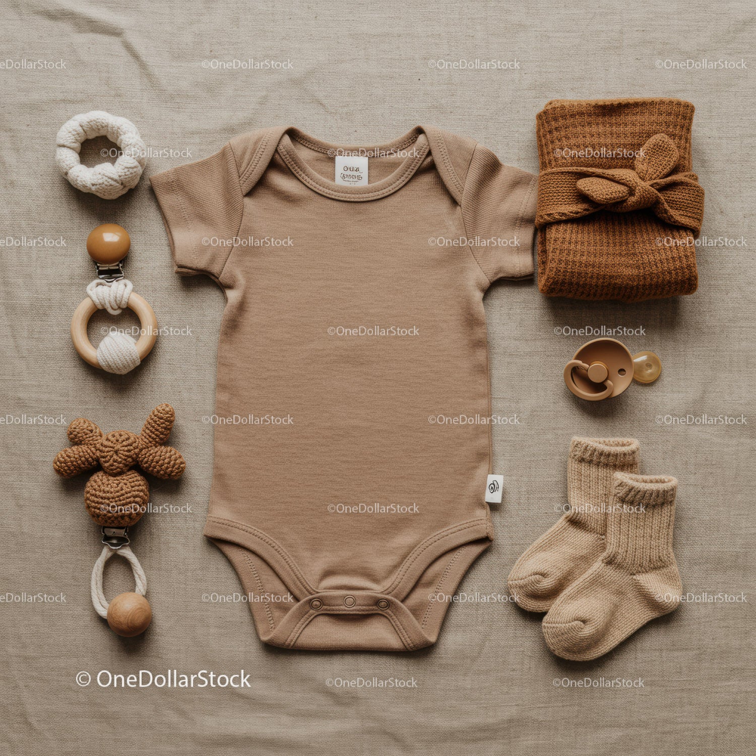 Neutral baby outfit with accessories on linen fabric
