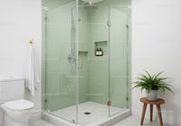 Modern glass shower with green tiles and fresh decor