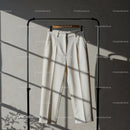 Elegant white trousers hanging in soft natural light