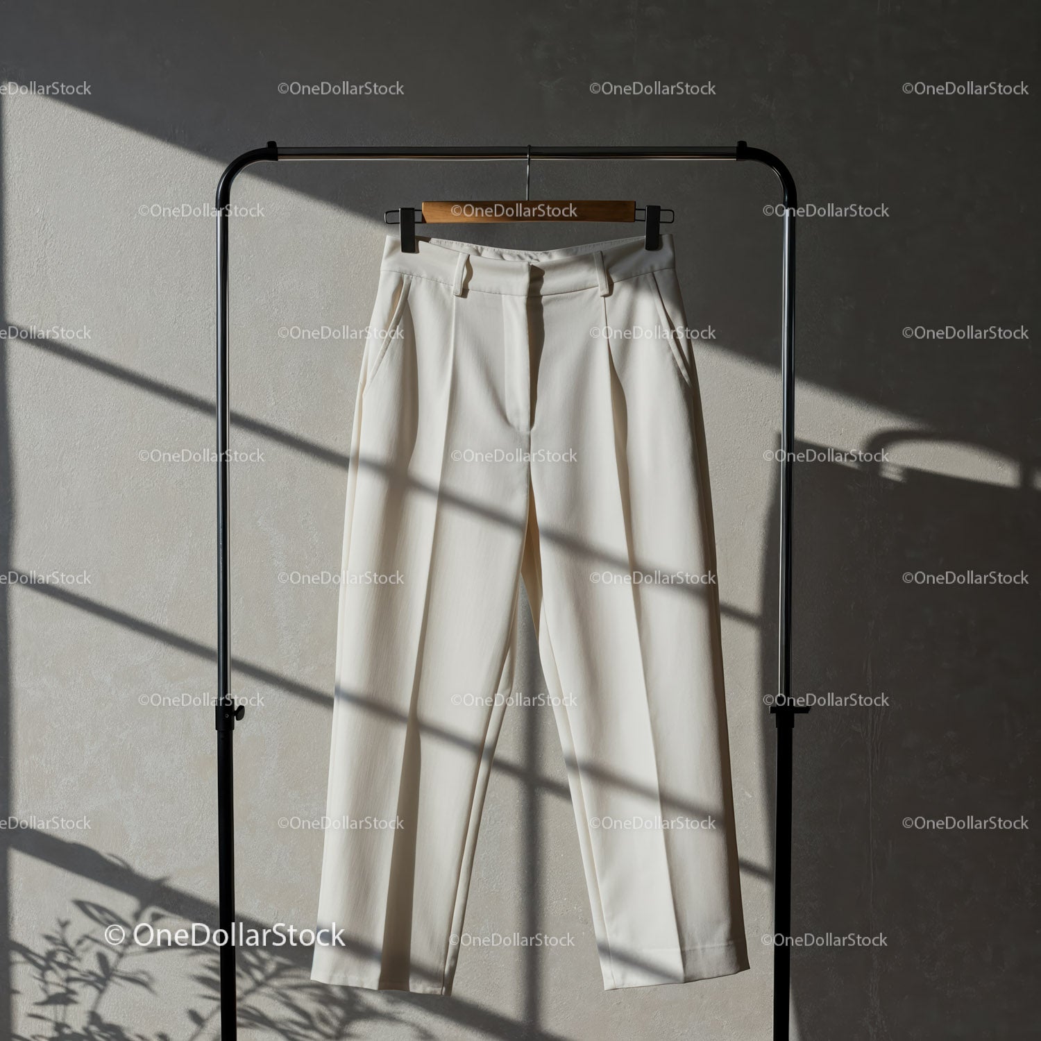 Elegant white trousers hanging in soft natural light