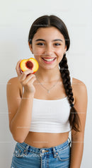 Happy Young Woman with Peach in Bright Casual Outfit