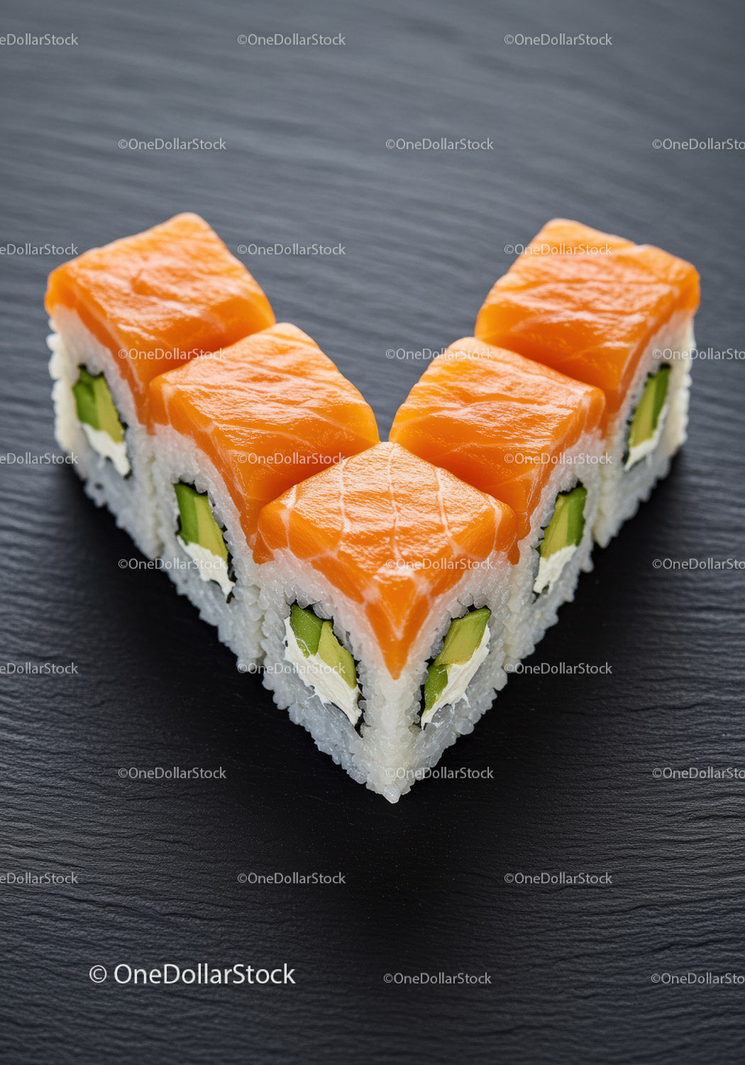Fresh salmon sushi rolls arranged in a heart shape