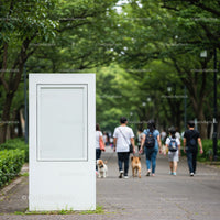 Empty white billboard in park with people walking dogs