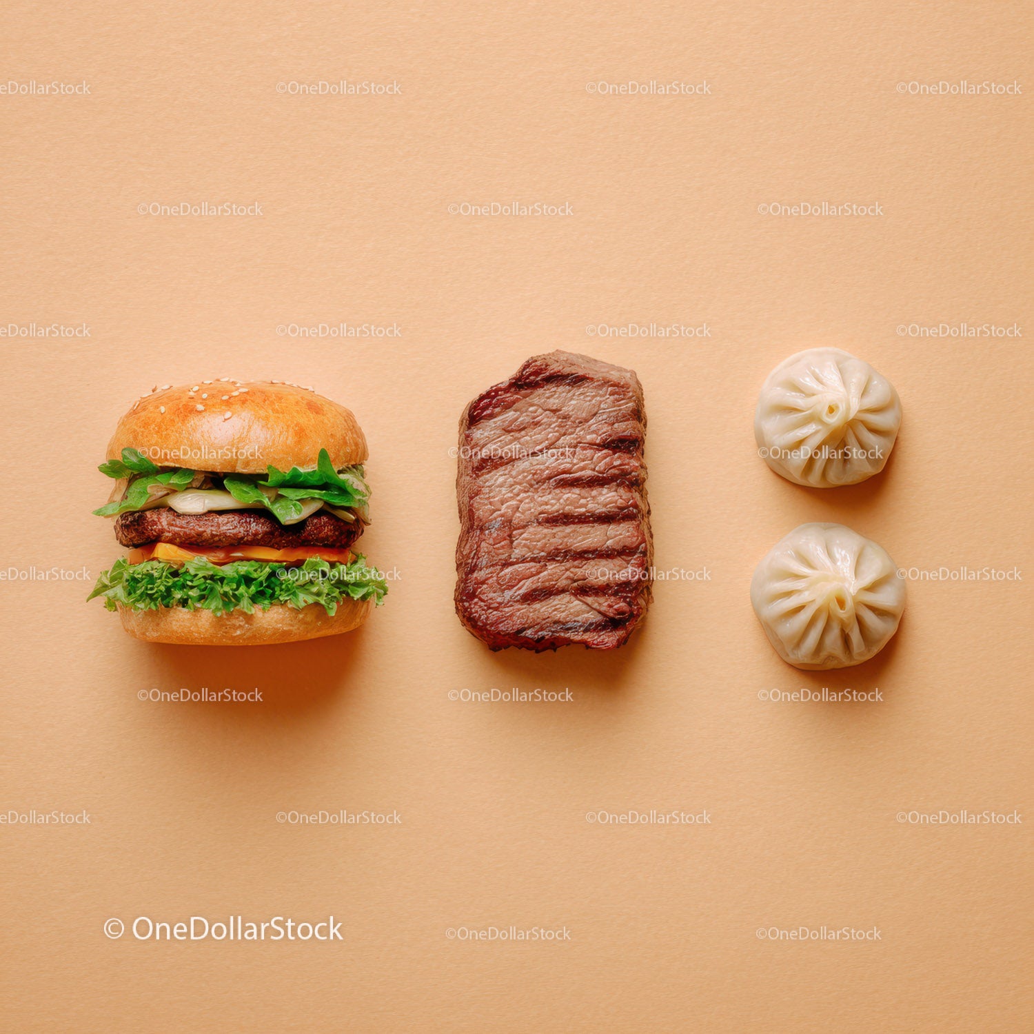 Gourmet Burger with Lettuce and Tomato Next to Grilled Steak and Dumpling