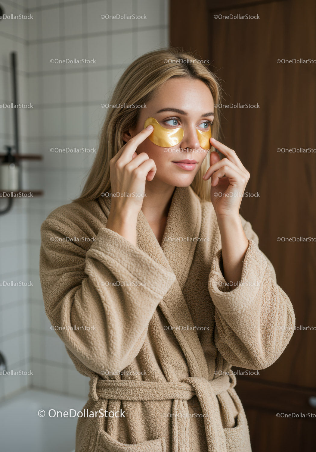 Woman with Gold Eye Patches Applying Skincare Treatment