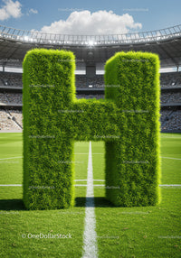 Large Green Letter H Made of Grass on Football Field