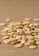 Close-Up of Rolled Oats and Grain Seeds on Brown Surface