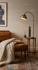 Cozy leather chair with knitted blanket and warm lighting