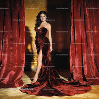 Elegant woman in deep red velvet evening gown