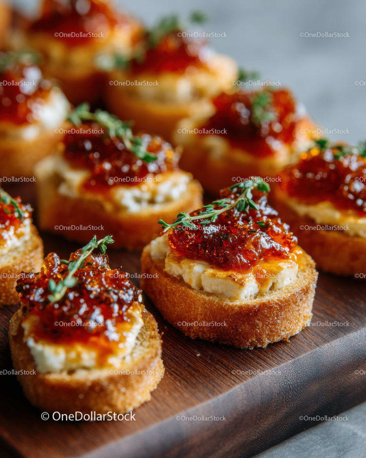 Gourmet Crostini with Cheese and Red Pepper Jelly on Rustic Platter