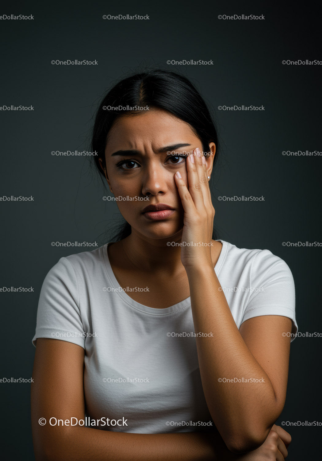 Concerned Young Woman with Hand on Face Showing Emotional Distress
