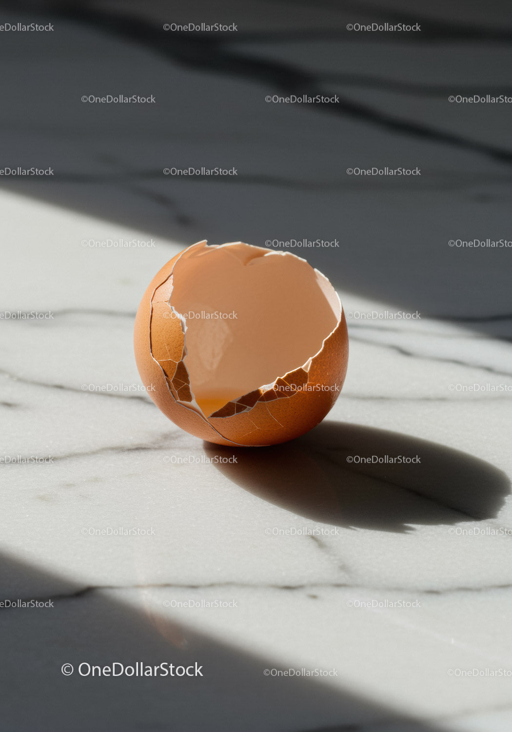 Cracked brown eggshell on marble kitchen surface