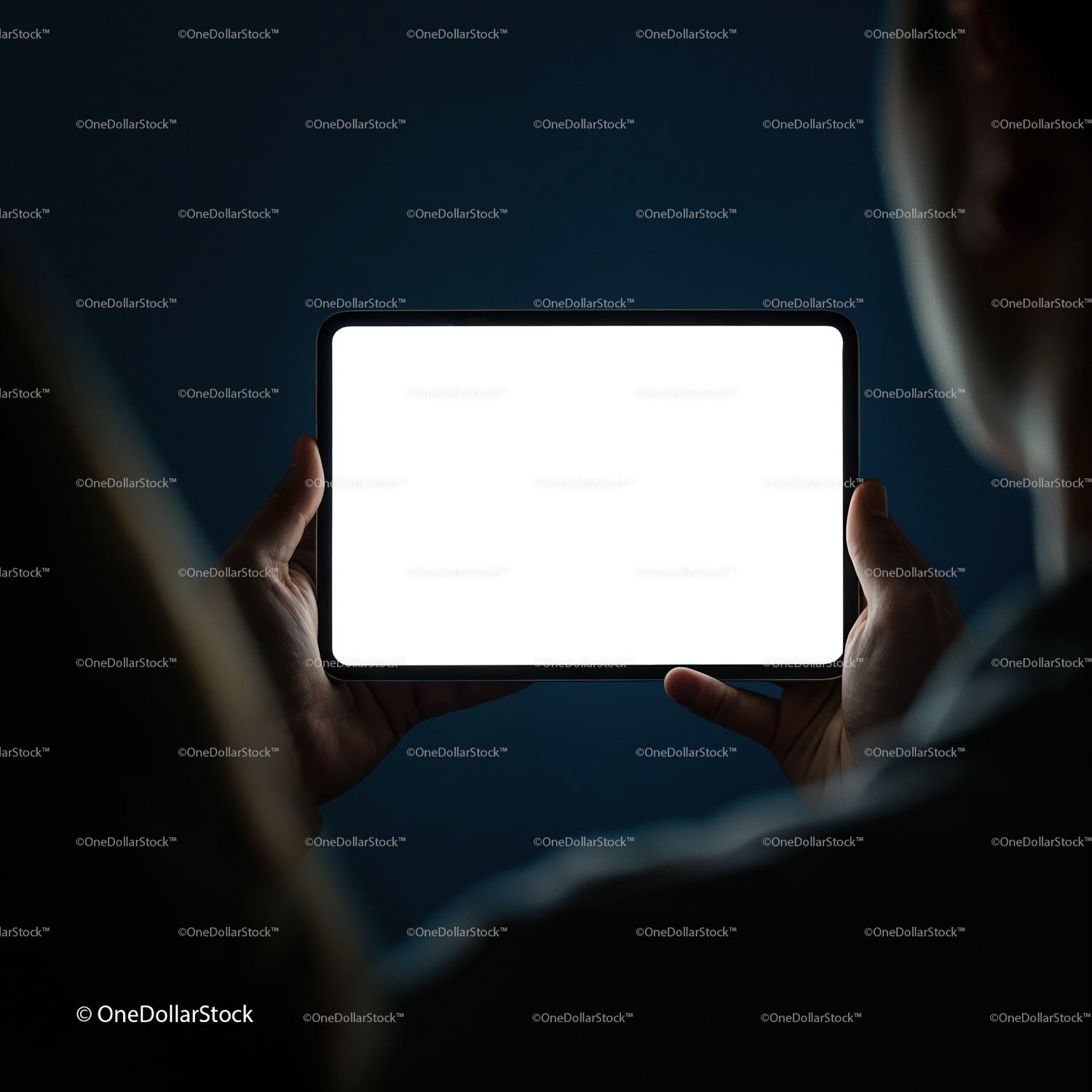 Person Holding Tablet with Bright Screen in Dark Room