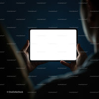 Person Holding Tablet with Bright Screen in Dark Room