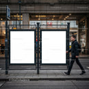 Blank advertising boards at urban bus stop with pedestrian