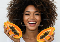 Smiling African American Woman Holding Halves of Fresh Papaya