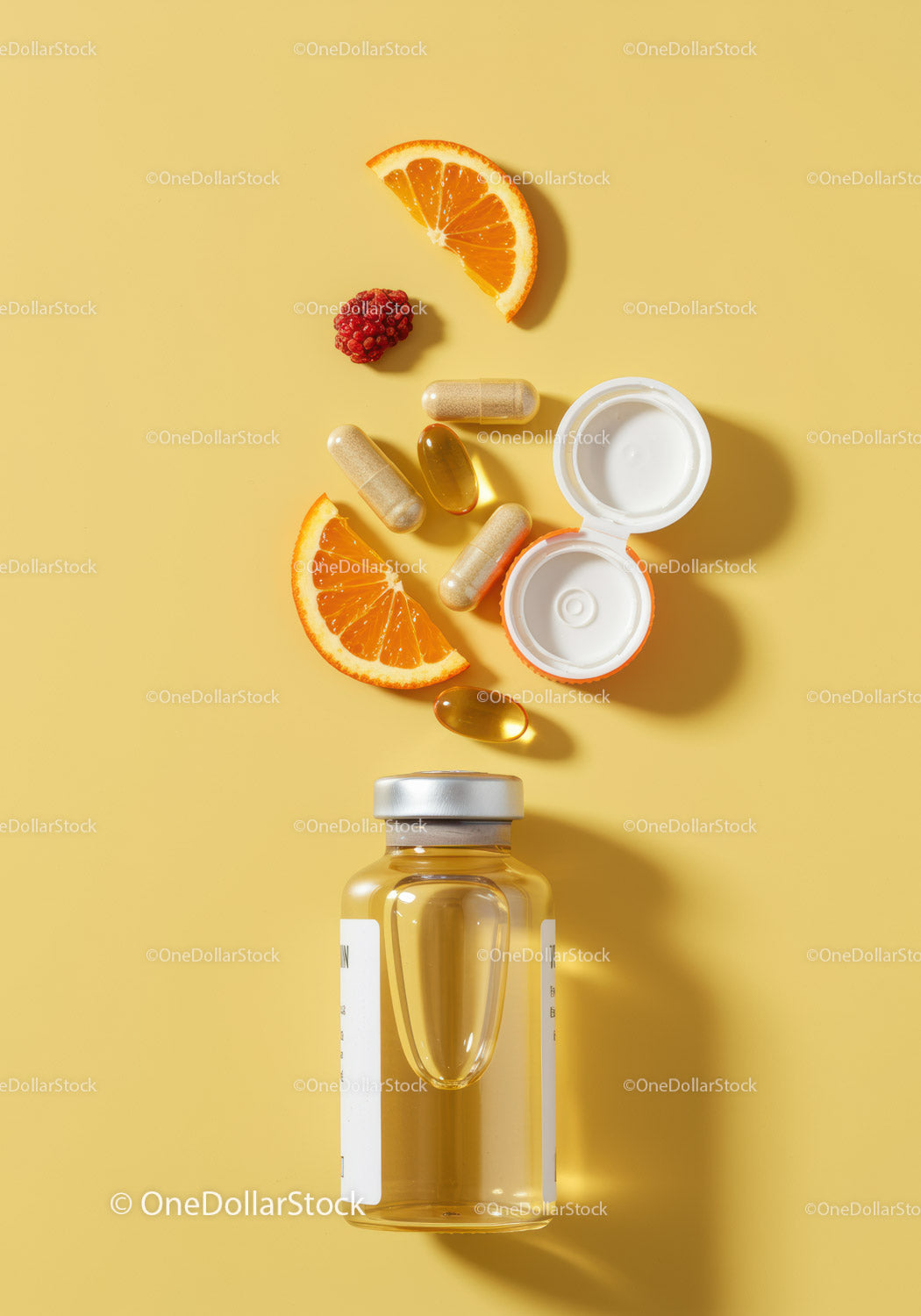 Vitamins and fresh fruit slices on yellow background