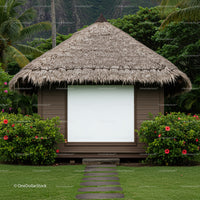 Tropical thatched hut surrounded by green hibiscus bushes