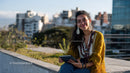 Young Woman Enjoying Outdoor Cityscape with Smartphone
