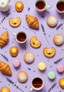 Assorted French Pastries and Tea Cups on Lavender Background