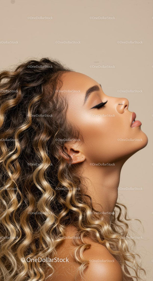 Profile of woman with curly hair and elegant makeup