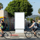 Urban street scene with blank billboard and cyclists