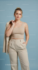 Stylish Woman in Beige Crop Top and Cream Pants in Modern Studio