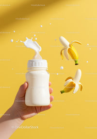 Baby bottle with milk splash and fresh peeled bananas