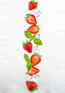 Fresh strawberries with basil leaves and ice cubes in water