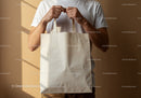 Man Holding Blank Cotton Tote Bag in Warm Light